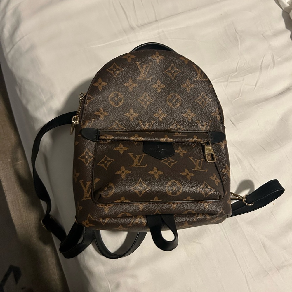 Brown monogrammed mini backpack. INSPIRED